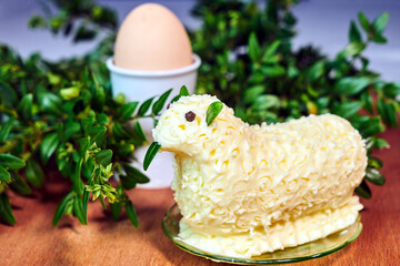 Easter lamb with butter on a background of colorful flowers