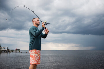 man casting a fishing pole