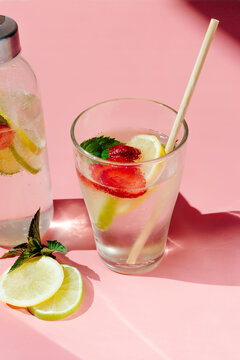 Glass bottle and cup with fruit beverage