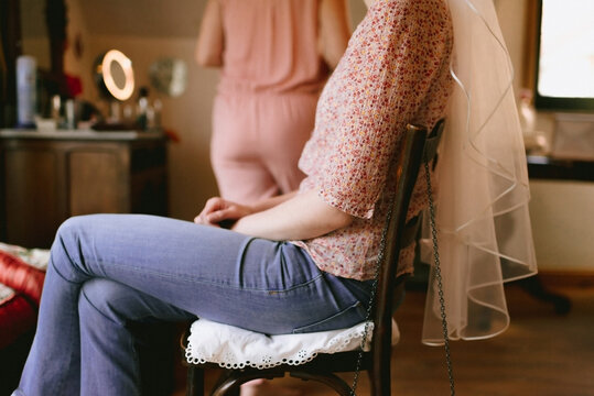 close up of bride sitting on a chair with veil