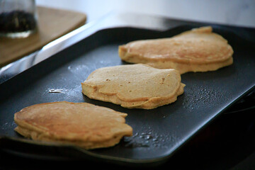 Fototapeta na wymiar Hot pancakes on a griddle