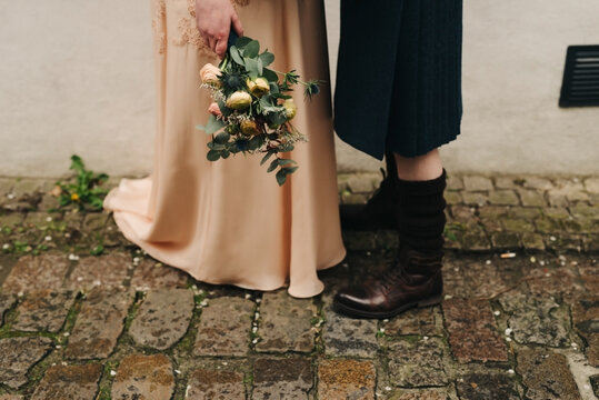 close up of Scottish groom wearing a kilt and bride with beautiful pastel colored wedding dress