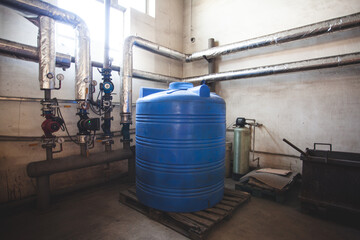 The large blue water barrel in boiler room at the enterprise