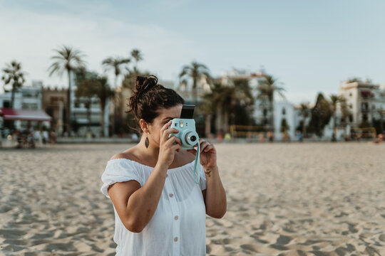 Woman taking a photo at the beach