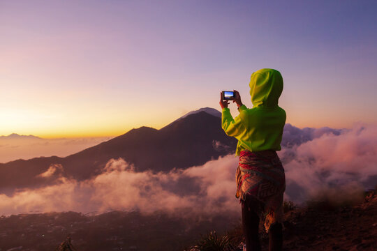 Woman photographs the landscape on the phone