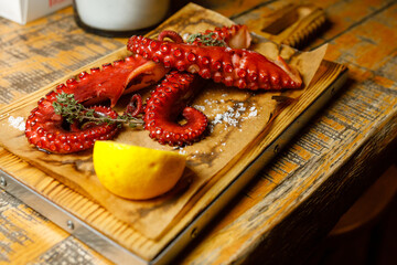 octopus and lemon platter on utensils