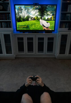 Girl Sits Upside Down To Play Shooter Video Game