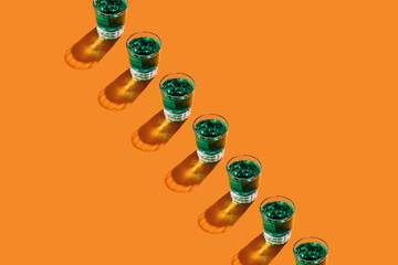 Green lemonade drinks in glasses strong shadows