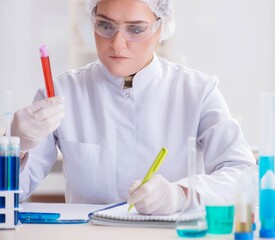 Woman doctor checking blood samples in lab