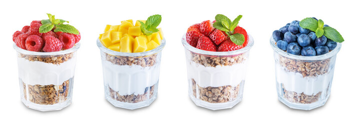 Set of Greek yogurt granola parfaits with strawberries, blueberries, mango fruits and raspberries in a glass on a white isolated background