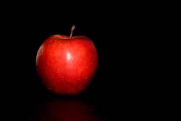 Red apple isolated on a black background with space for text