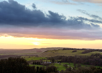Fototapeta na wymiar scenic Westerly view over as the golden sun sets over Oare and across the Pewsey Vale valley