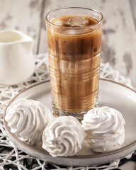 Iced coffee drink with homemade zephyr, sweet breakfast still life, vertical