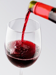 Pouring red wine into a glass