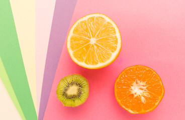 Variety of Different Tropical Seasonal Summer Fruits. Citrus Orange   Lemons  Kiwi   on Overlapping Paper in Trendy Pastel Colors: Pink , Purple   Background. Healthy Lifestyle Diet Vitamins. Flat Lay - 420589188