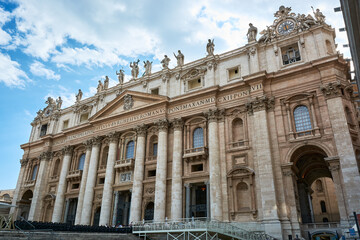 Fototapeta na wymiar A view of the facade of St. Peter's Basilica at Saint Peter's Square in the Vatican City in Rome, Italy, under blue cloudy sky on a spring day.