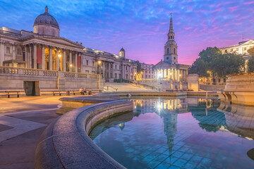 Night cityscape with a colourful, dramatic sky at sunrise or sunset at Trafalgar Square and the National Gallery in central London, UK. - obrazy, fototapety, plakaty