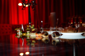 buffet table with toasts and snacks and desserts in red tones