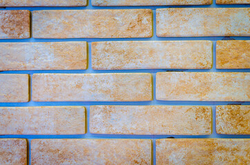 Brick wall in yellow with gray lines.