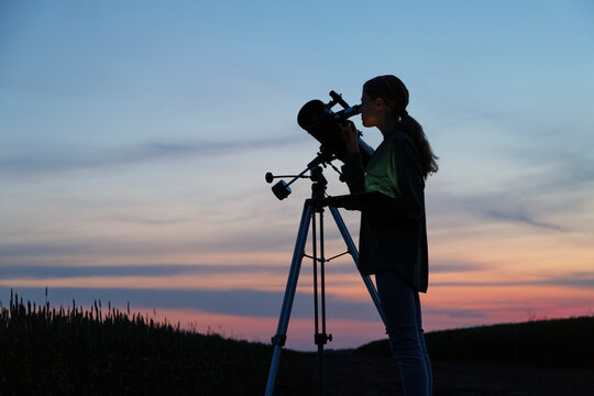 Anonymous stargazer looking at sundown sky