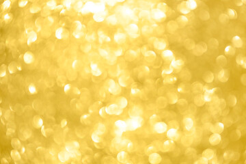 Abstract shiny glitter christmas or new year background. Light Gold glitter background with sparkling texture. Golden shimmering light, sequins sparks and glittering glow foil background.