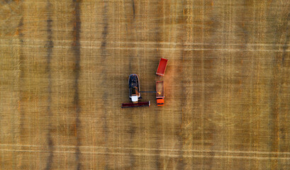 Industrial machinery harvesting crops in field