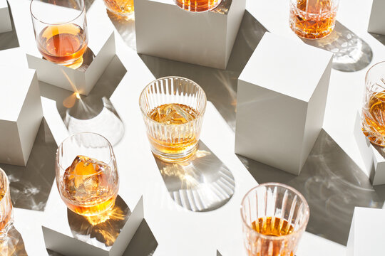 Glasses of whiskey near cubes