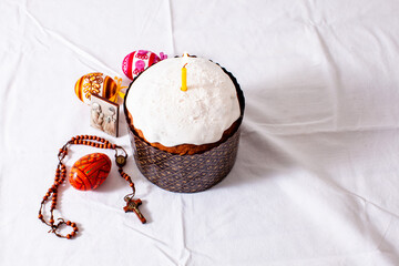 Easter cake and colored eggs on white background