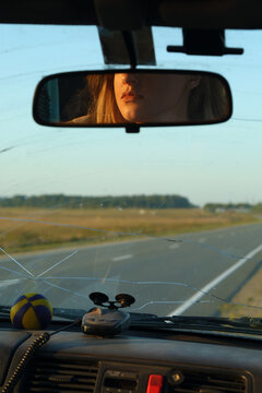 Reflection of woman against cracked windshield