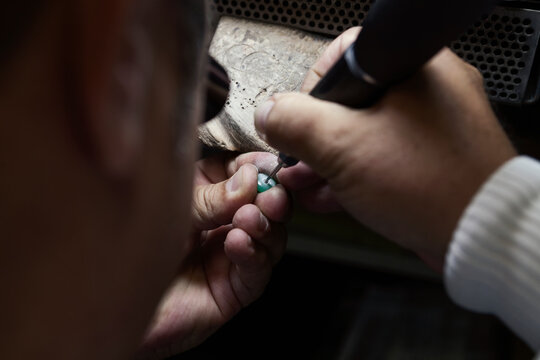 Artisan work on jewel close-up, man portrait