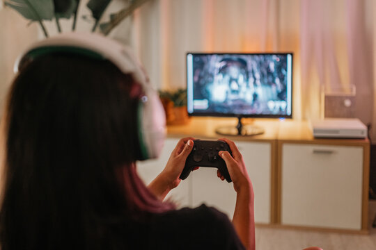 Unrecognizable woman gaming at home