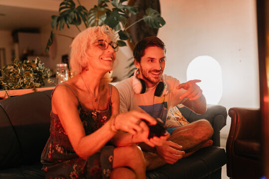 Mother and son playing videogames at home