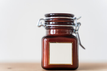 Scented candle in a glass jar on a white background
