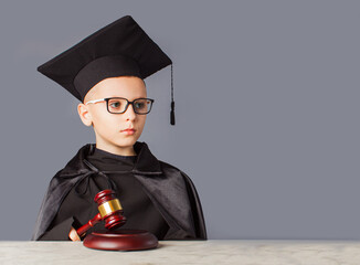 Portrait of serious smart child in graduation cap