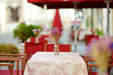 Outdoor restaurant table beautifully decorated with plants and flowers in Vilnius, Lithuania
