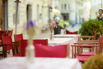 Outdoor restaurant table beautifully decorated with plants and flowers in Vilnius, Lithuania
