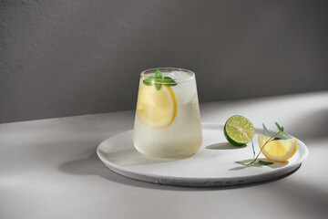 Cold fresh lemonade on gray cement background.