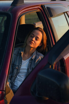 Female driver sleeping in car