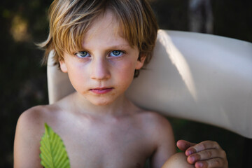 Portrait of a little boy holding a leaf
