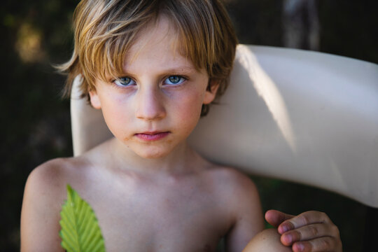 Portrait of a little boy holding a leaf