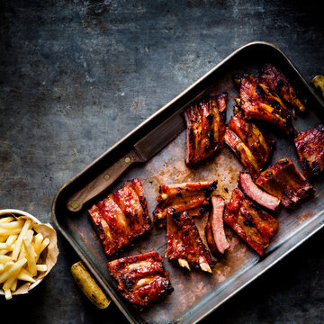 Marinated bbq ribs a bowl of fries and copy space
