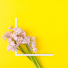 Creative layout with pink hyacinth on illuminating yellow background. Minimal spring concept. Flat lay.