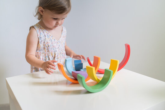 Toddler playing with colorful toys