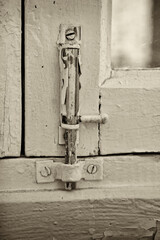 Window of an old house in the city. The window frames are closed with a vintage retro latch.