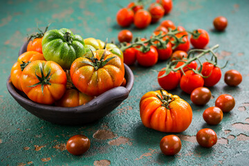 Assortment of organic tomatoes on old kitchen table