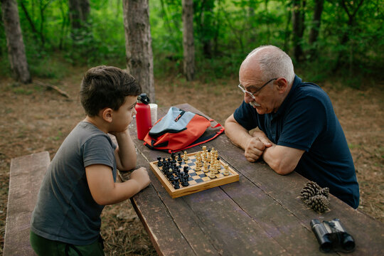 Grandfather playing chess with his grandson