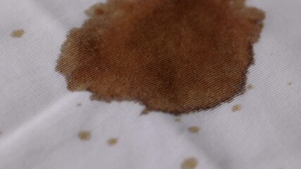 Coffee drop on the shirt. A white cotton shirt stained with brown coffee