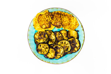 crepes and eggplant on green plate in white background