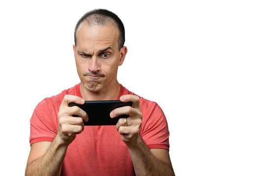 Mature man in casual clothes, with an eyebrow raises and holding the smartphone horizontally.