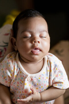 Cute newborn baby on her mother's lap